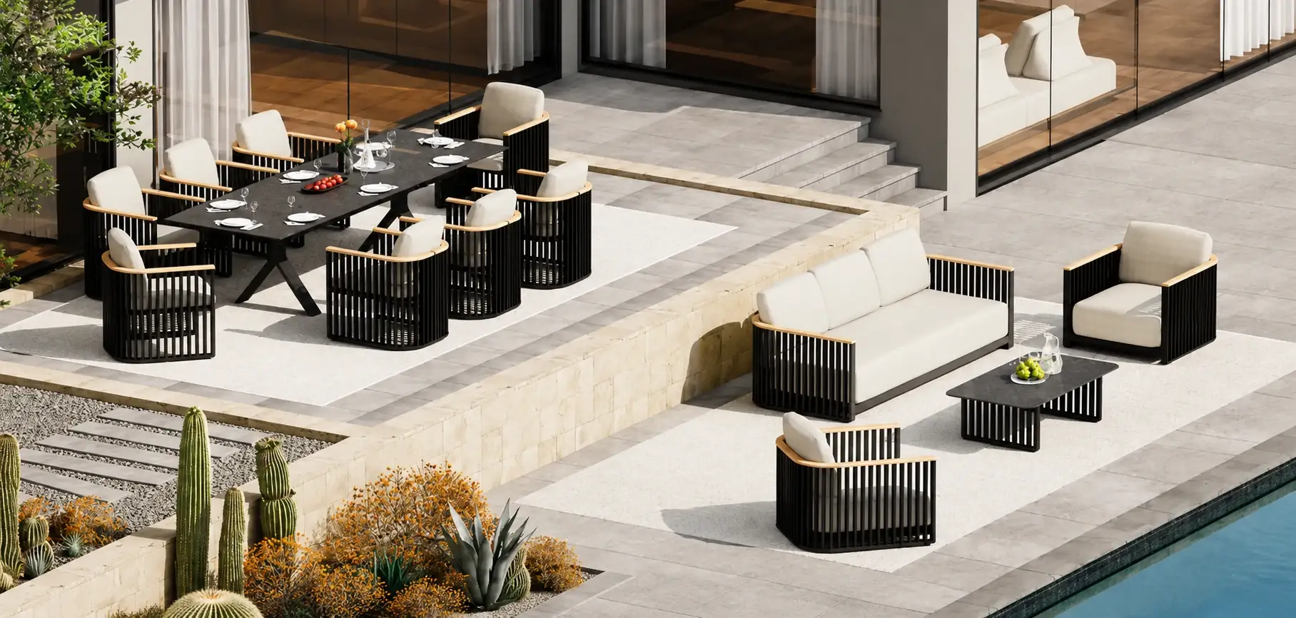 Outdoor dining and lounge setting on a villa terrace with desert planting