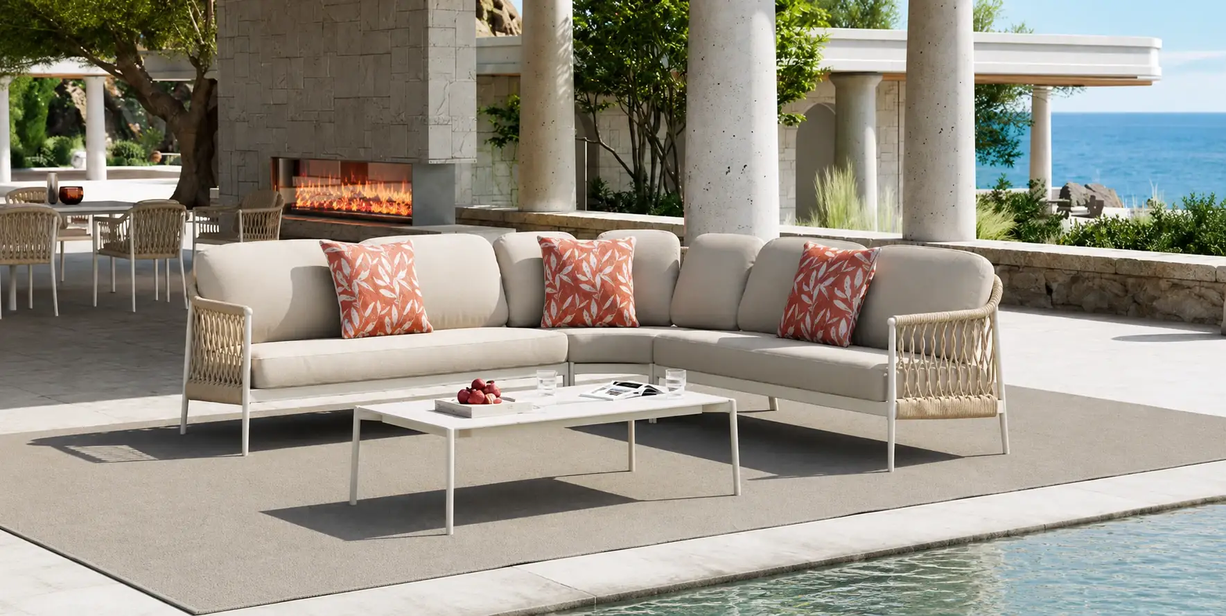 Cream poolside sectional with coral patterned cushions