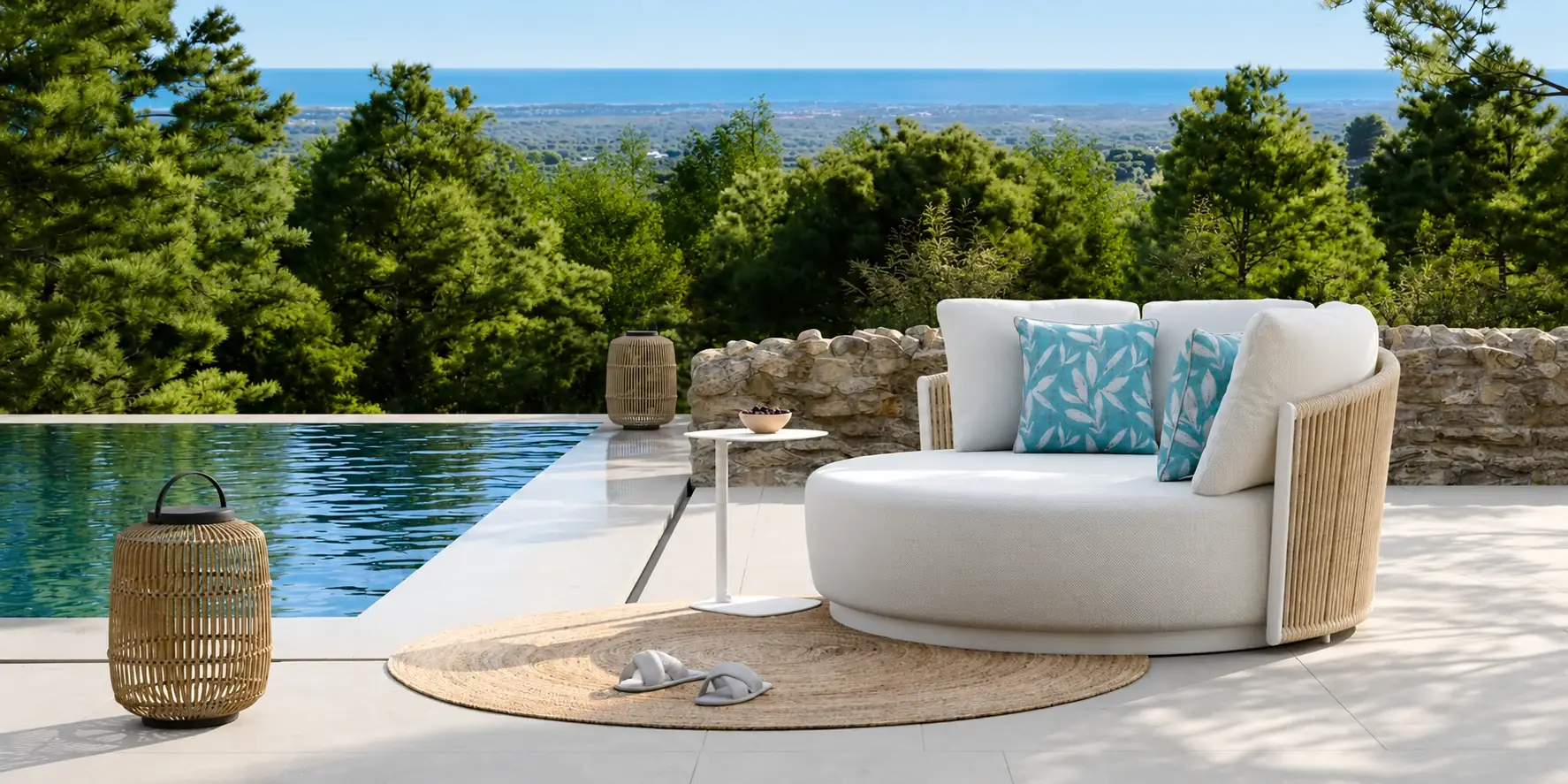 Round rattan daybed at the edge of an infinity pool