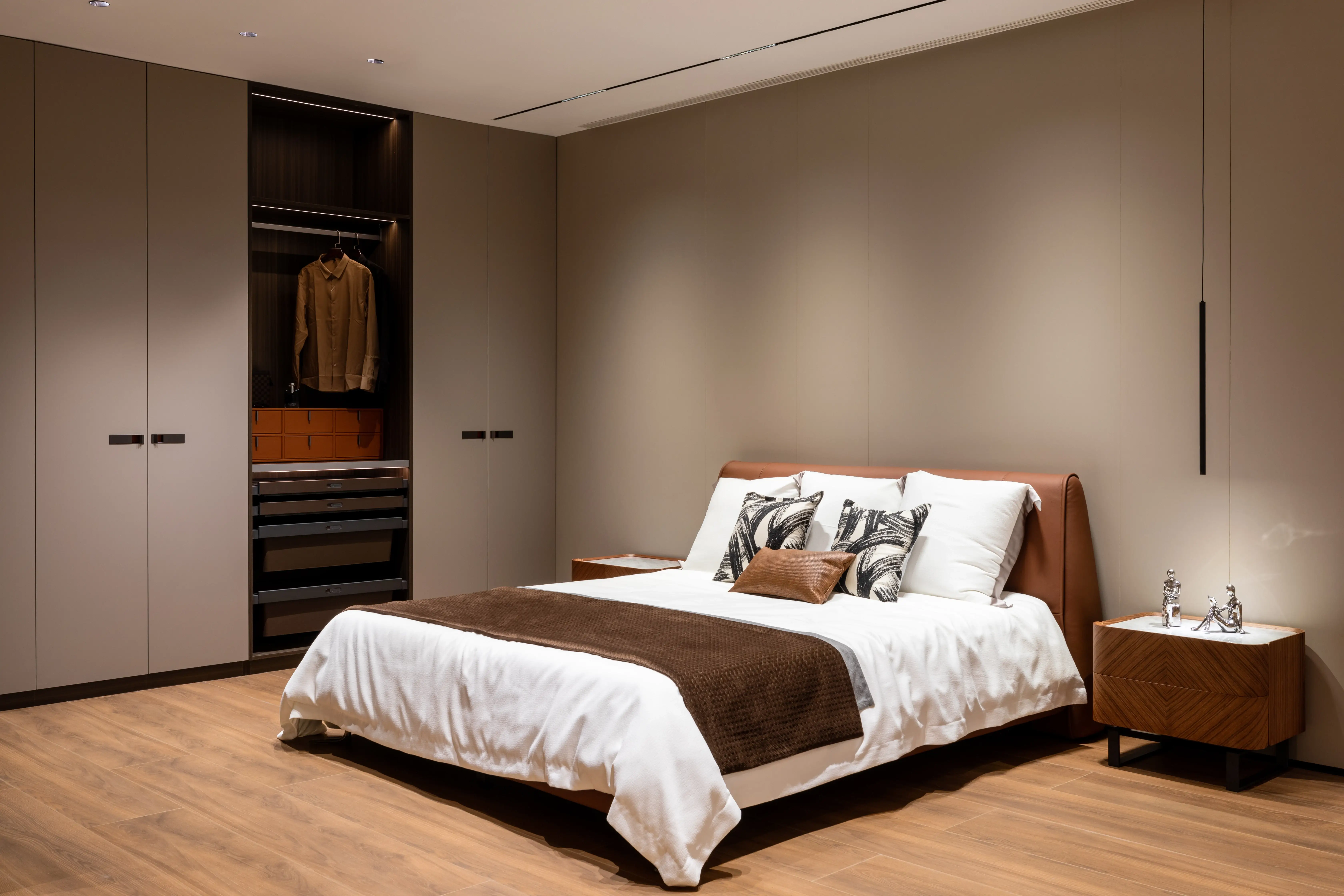 Bedroom with open wardrobe and warm brown and white bedding