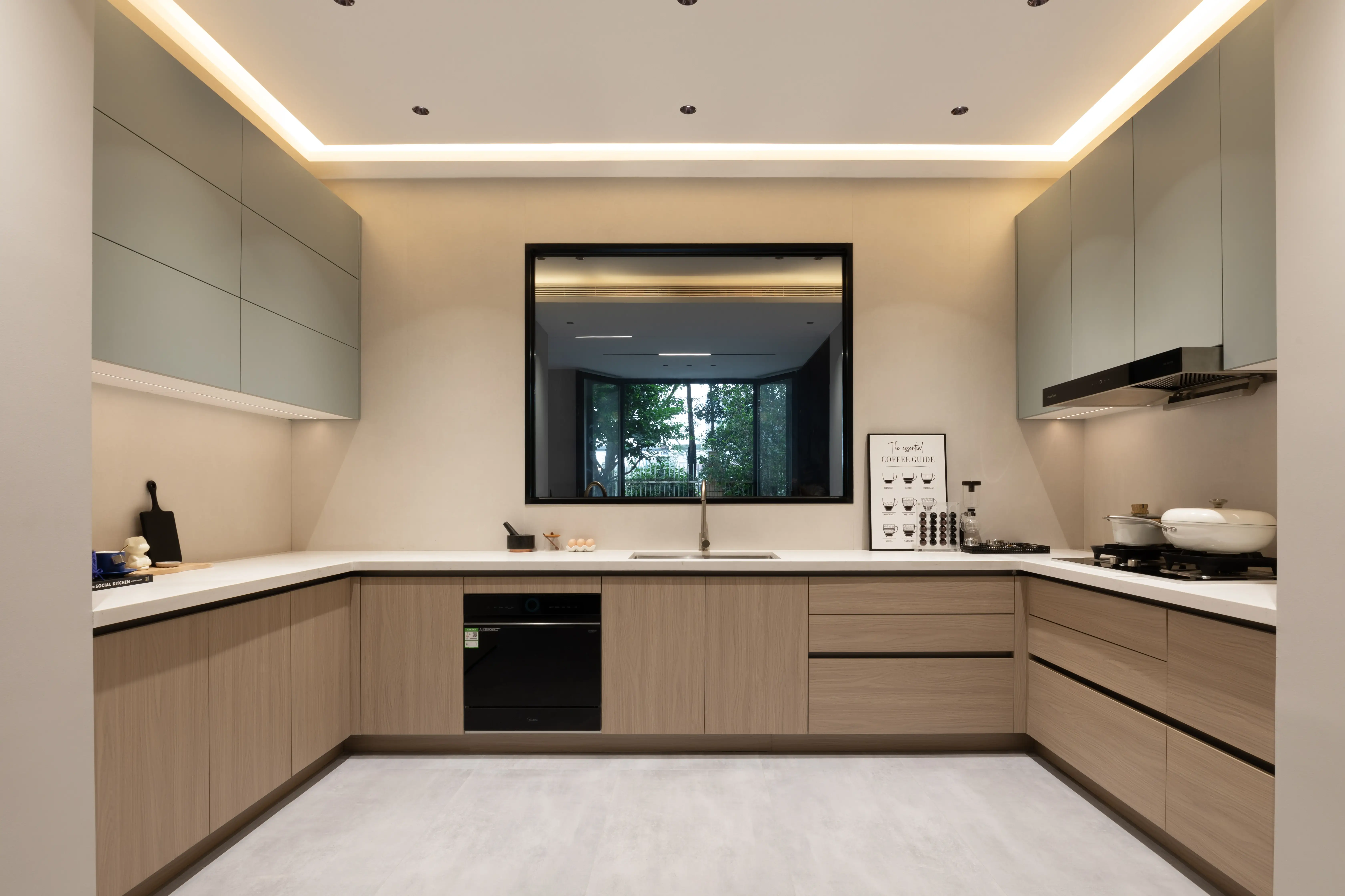 Warm beige U-shaped kitchen with cove lighting and a framed window
