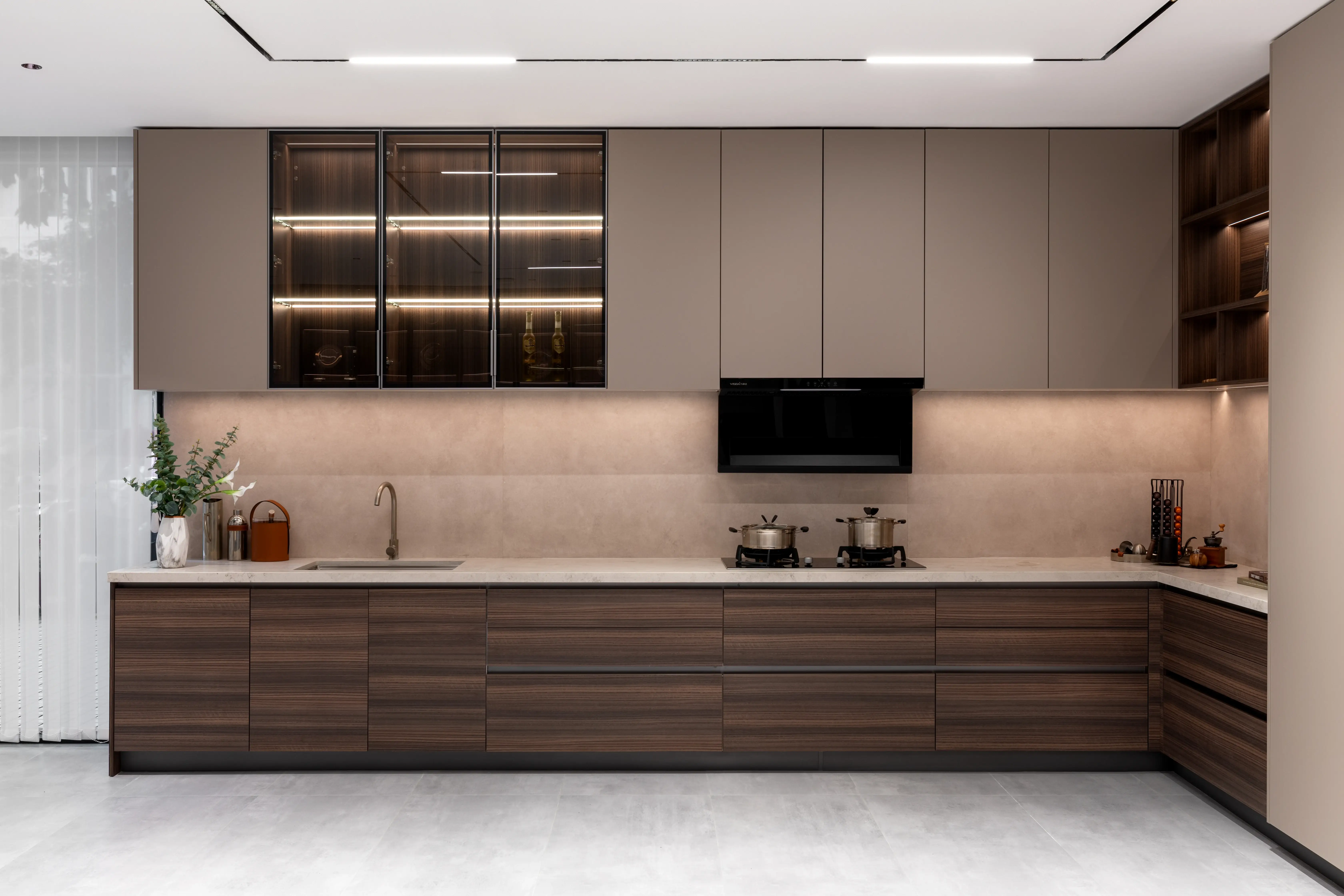 Walnut and white galley kitchen with integrated cove lighting
