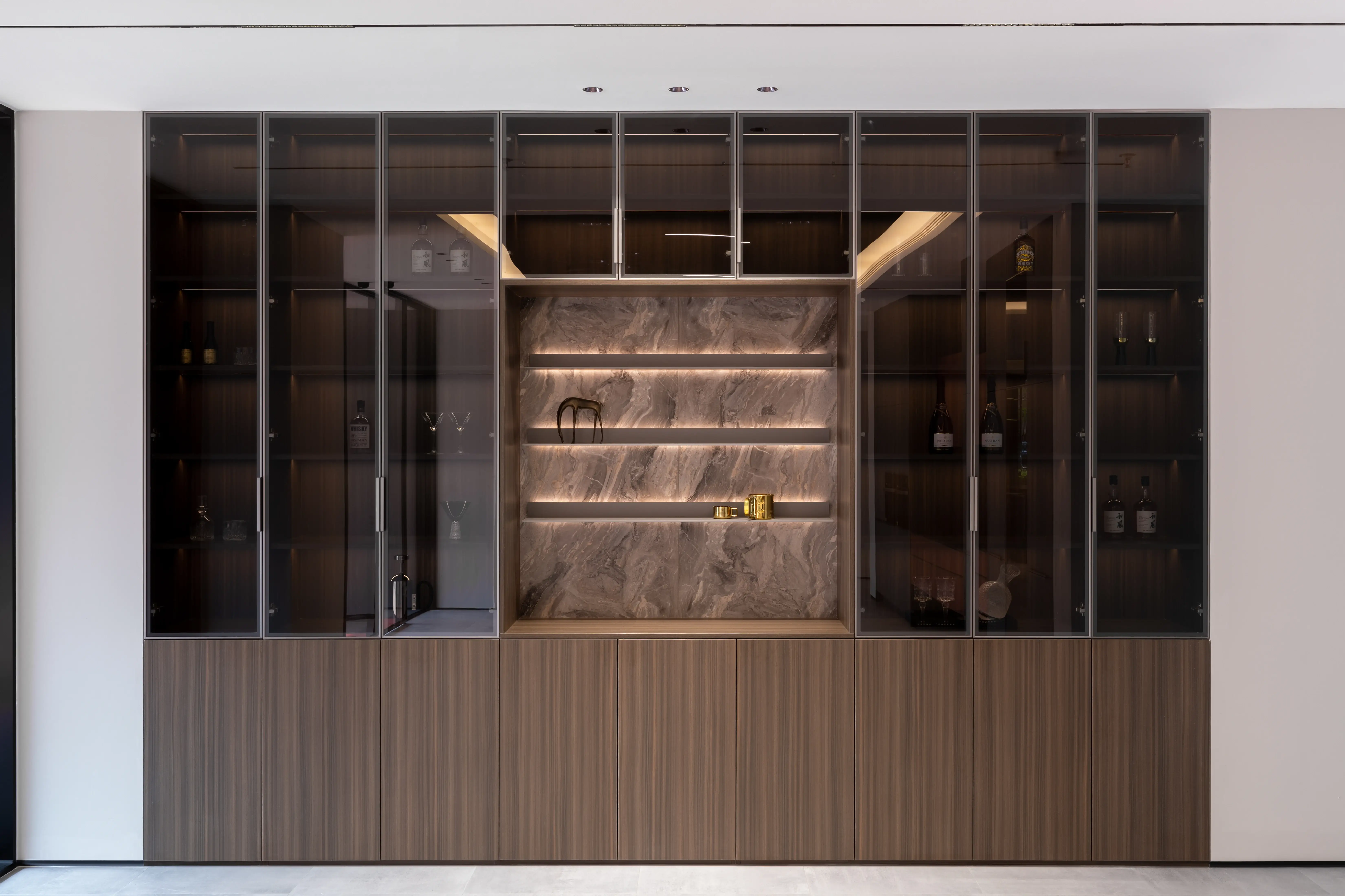 Dark kitchen with deep burgundy cabinetry and integrated black appliances