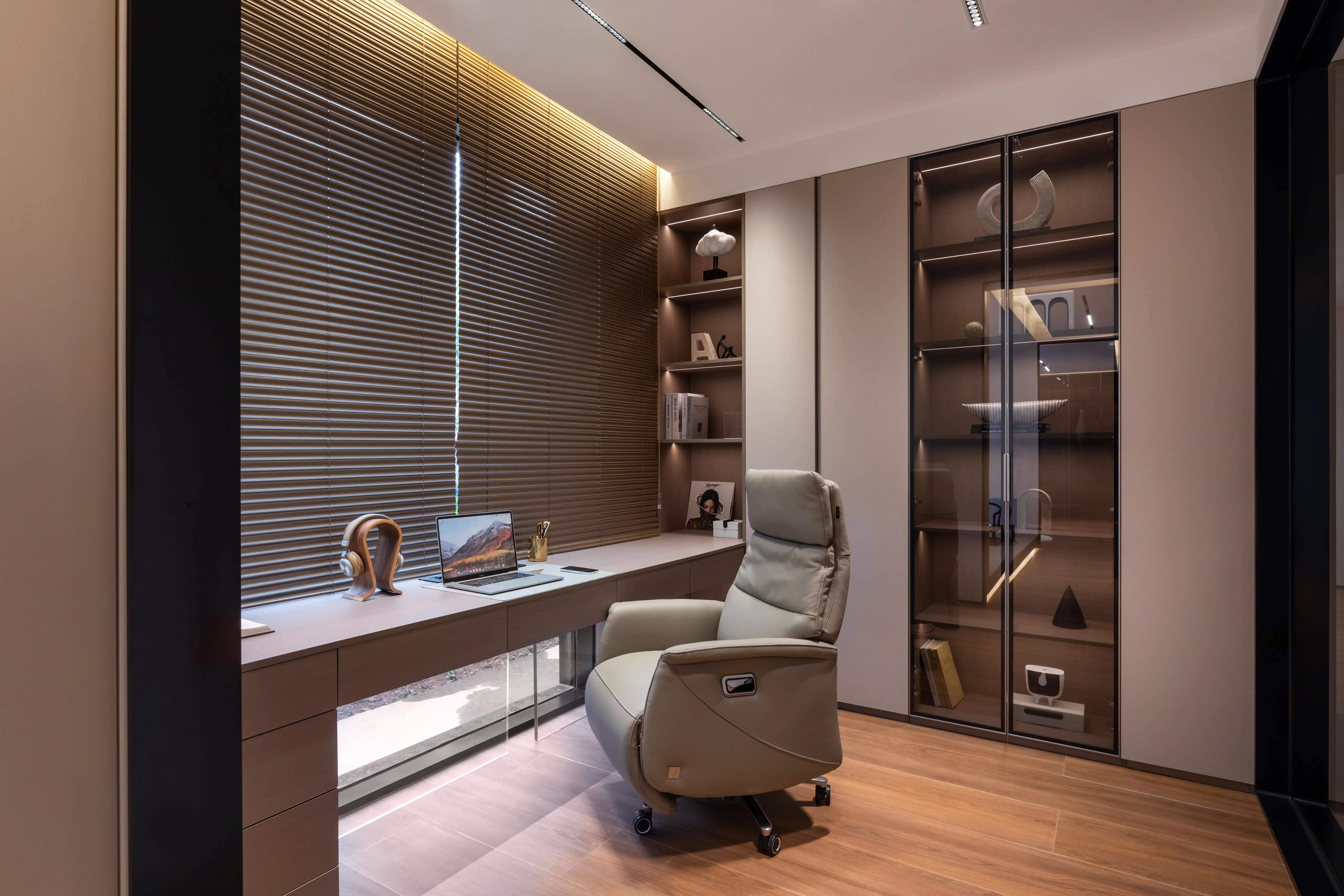 Study with built-in desk, leather recliner and glass display cabinet